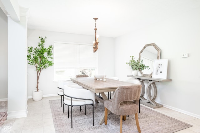 dining space with light tile patterned flooring and baseboards