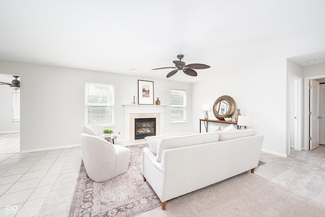 living area featuring ceiling fan, plenty of natural light, and a high end fireplace