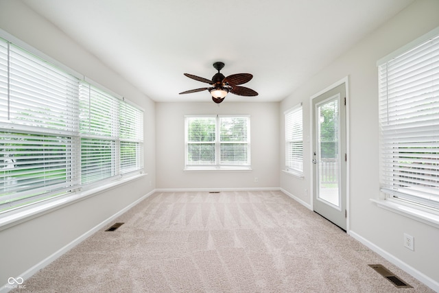 spare room featuring carpet flooring, a ceiling fan, and baseboards
