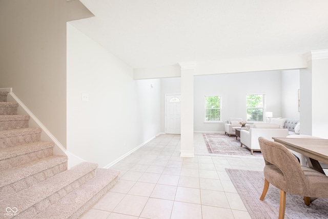 entryway featuring stairway, light tile patterned flooring, and baseboards