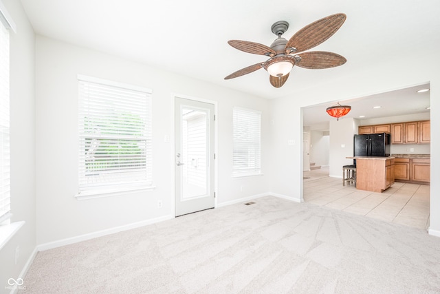 unfurnished living room with light carpet, ceiling fan, baseboards, and recessed lighting