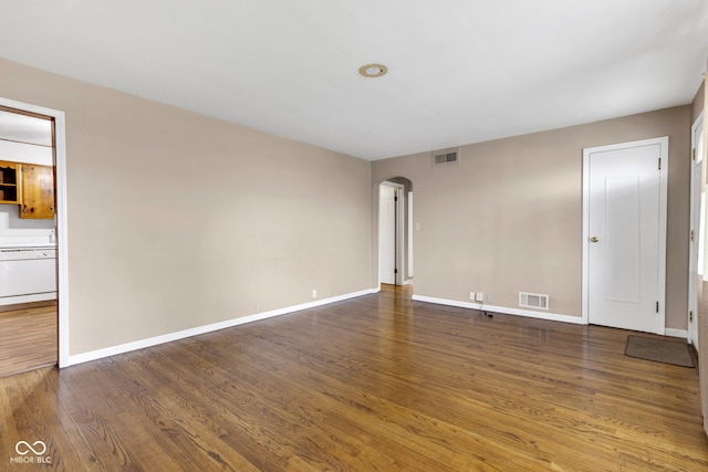 518 N Carr Rd, Plainfield, IN 46168 - spare room featuring arched walkways, wood finished floors, and baseboards