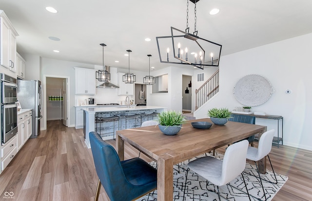 591 Dalton Way, Avon, IN 46123 - dining area with baseboards, recessed lighting, light wood-style floors, a chandelier, and stairway