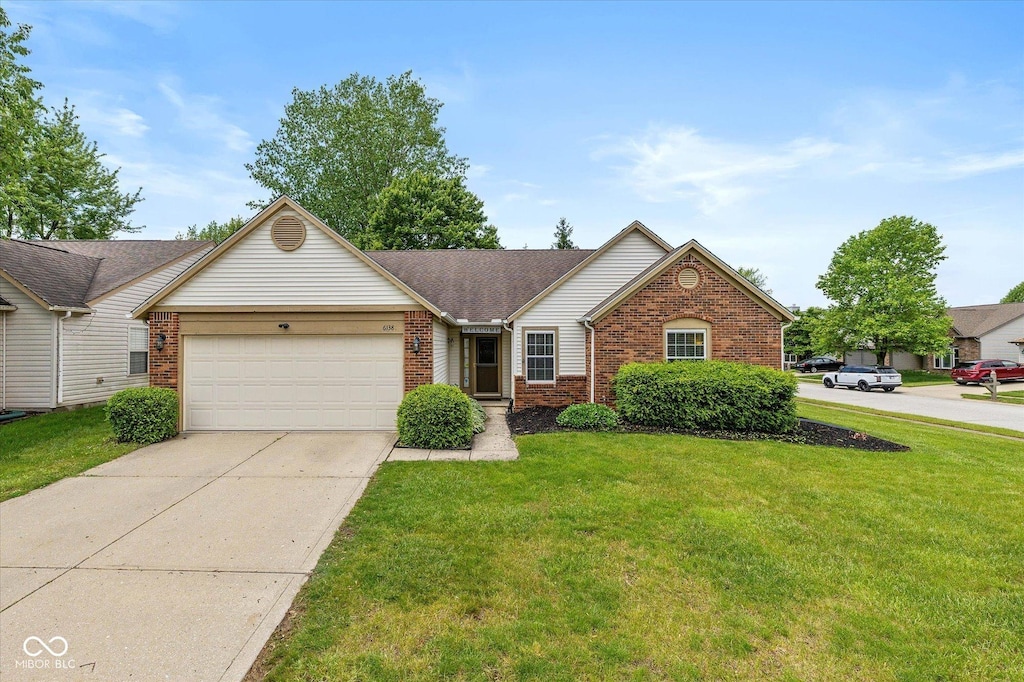 6138 Bartley Ct, Indianapolis, IN 46236 - view of front of house featuring brick siding, a garage, a front yard, driveway, and a shingled roof