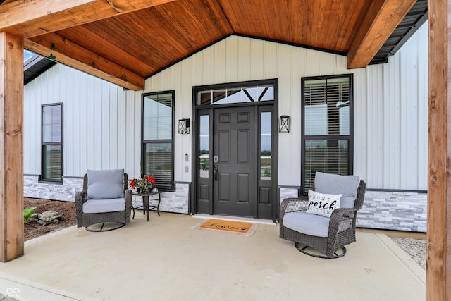 doorway to property with stone siding and a porch