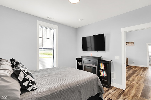 bedroom with wood finished floors and baseboards