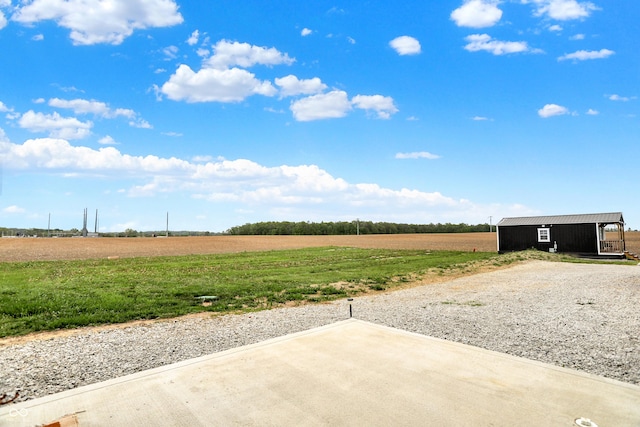 view of yard with a view of rural / pastoral area and a patio