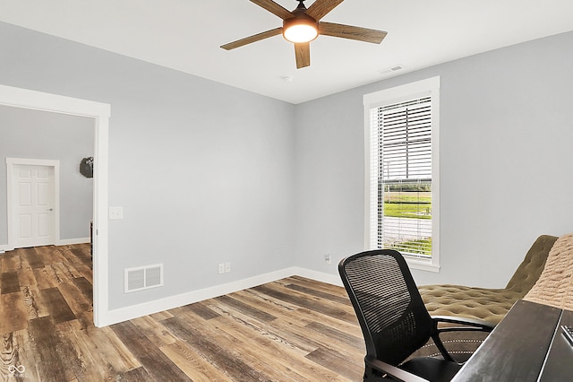 home office with ceiling fan, baseboards, and wood finished floors