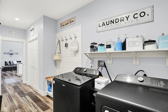 laundry room featuring washing machine and dryer, wood finished floors, baseboards, and recessed lighting
