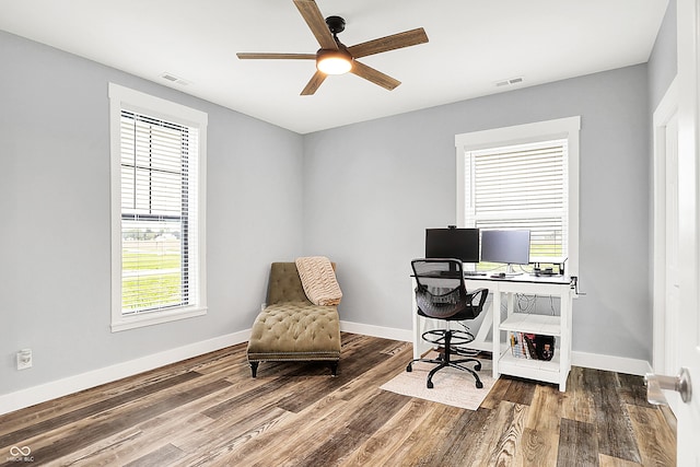 office with healthy amount of natural light, ceiling fan, wood finished floors, and baseboards