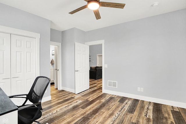 office with a ceiling fan, wood finished floors, and baseboards