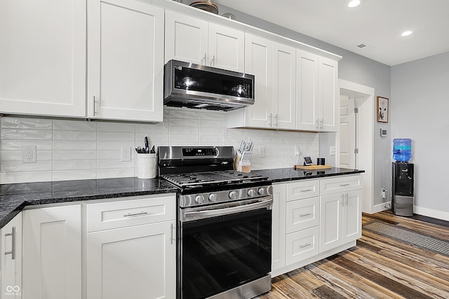 kitchen featuring appliances with stainless steel finishes, wood finished floors, recessed lighting, white cabinets, and baseboards