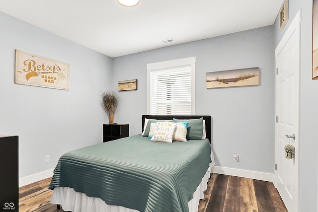 bedroom featuring baseboards and wood finished floors