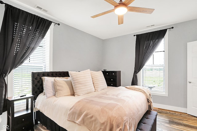 bedroom with wood finished floors, baseboards, and ceiling fan