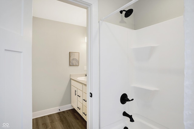 1429 Deloss St, Indianapolis, IN 46201 - bathroom with wood finished floors, baseboards, vanity, and bathtub / shower combination