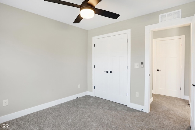1429 Deloss St, Indianapolis, IN 46201 - unfurnished bedroom featuring carpet, a closet, baseboards, and a ceiling fan