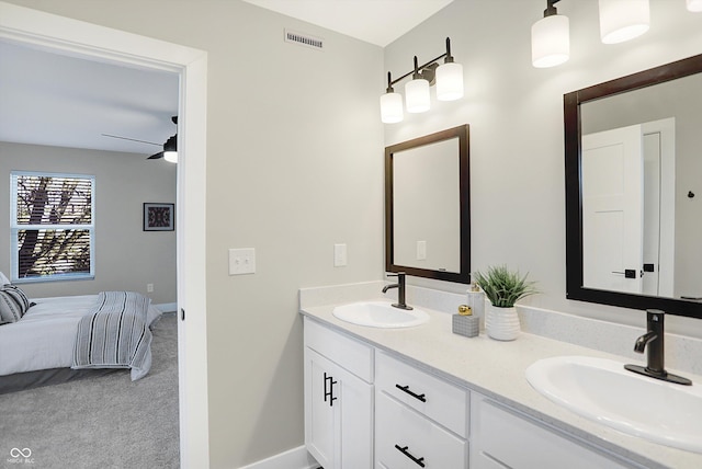 1429 Deloss St, Indianapolis, IN 46201 - full bathroom with double vanity, baseboards, ensuite bathroom, and a ceiling fan