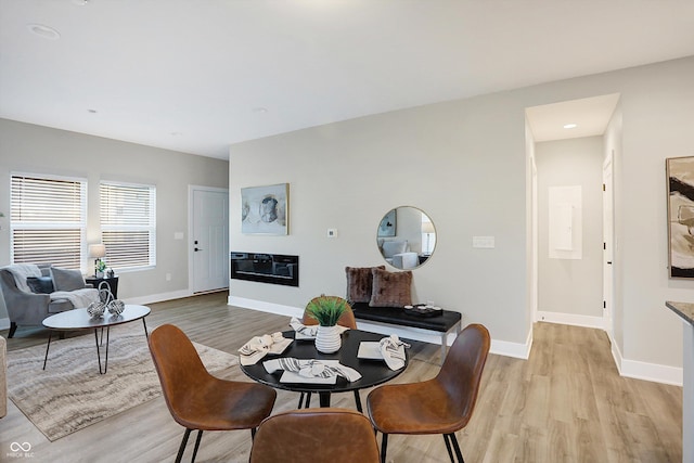 1429 Deloss St, Indianapolis, IN 46201 - dining area with light wood finished floors, baseboards, a glass covered fireplace, and recessed lighting