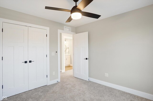 1429 Deloss St, Indianapolis, IN 46201 - unfurnished bedroom with light carpet, baseboards, a closet, and ceiling fan