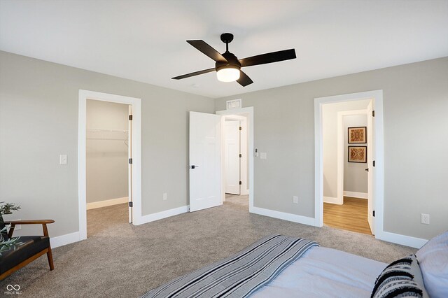 1429 Deloss St, Indianapolis, IN 46201 - bedroom with carpet flooring, a walk in closet, baseboards, and a ceiling fan