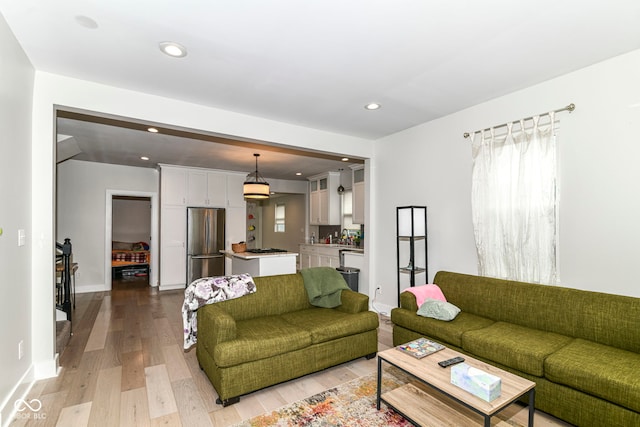 1043 N Beville Ave, Indianapolis, IN 46201 - living area with light wood finished floors, recessed lighting, and baseboards