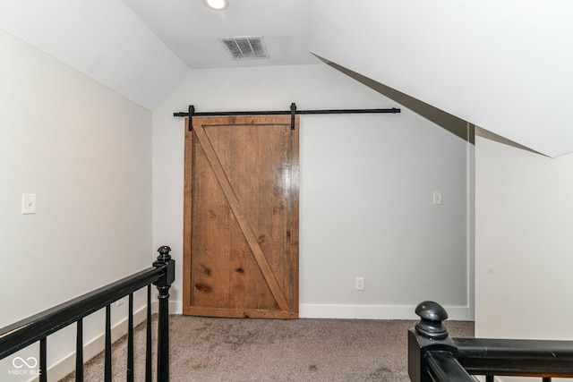 1043 N Beville Ave, Indianapolis, IN 46201 - exercise room featuring carpet, vaulted ceiling, and a barn door