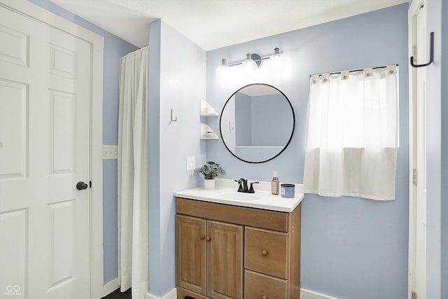 bathroom featuring vanity and baseboards