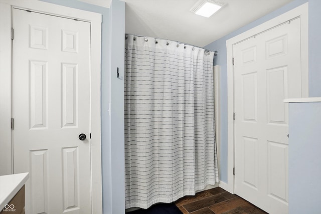 bathroom with wood finished floors, vanity, and a shower with shower curtain