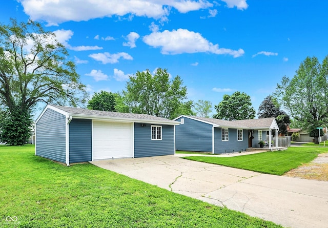 single story home with driveway, a detached garage, a front yard, and an outdoor structure