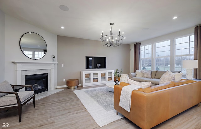 7239 Barrett Dr, Brownsburg, IN 46112 - living room featuring a chandelier, light wood-style floors, a fireplace, recessed lighting, and baseboards