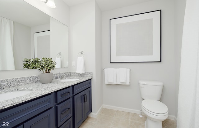 7239 Barrett Dr, Brownsburg, IN 46112 - full bath with double vanity, baseboards, toilet, and tile patterned floors