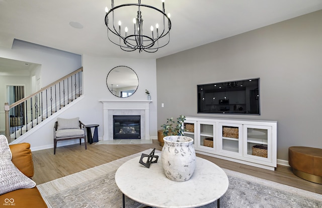 7239 Barrett Dr, Brownsburg, IN 46112 - living room featuring wood finished floors, a chandelier, stairs, a fireplace, and baseboards