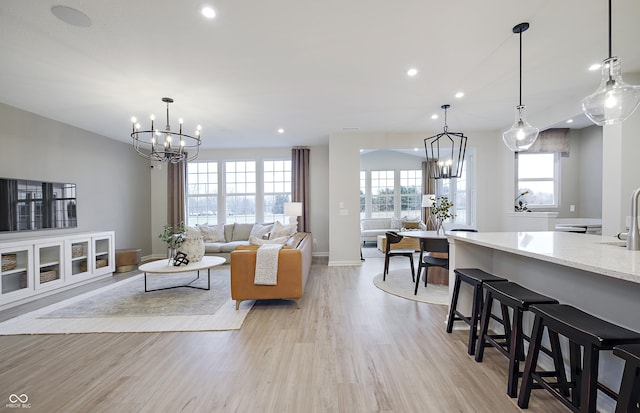 7239 Barrett Dr, Brownsburg, IN 46112 - living room featuring a chandelier, light wood-style floors, recessed lighting, and baseboards
