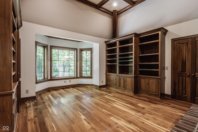 7406 N Washington Blvd, Indianapolis, IN 46240 - unfurnished living room featuring wood finished floors, baseboards, beam ceiling, coffered ceiling, and a towering ceiling