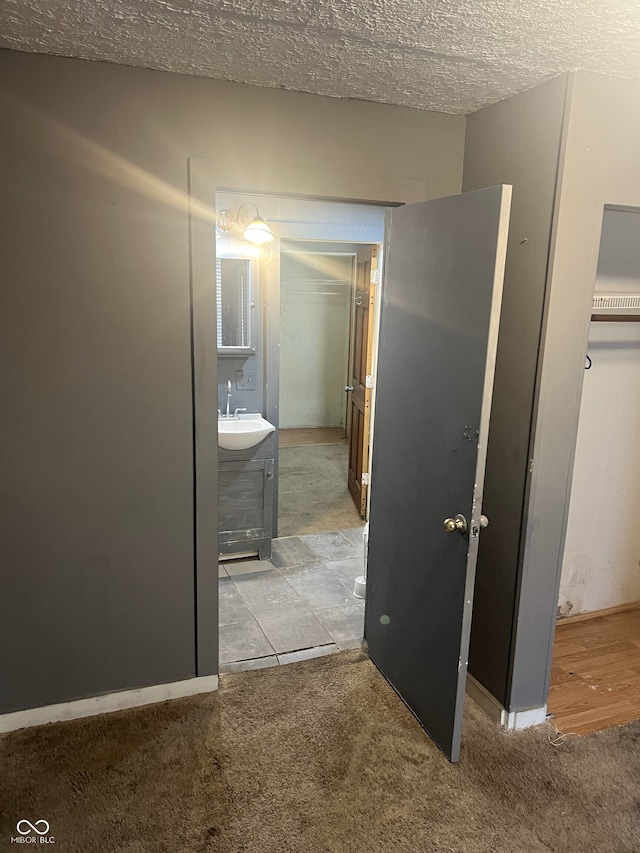 2146 Gent Ave, Indianapolis, IN 46202 - hall with a sink, carpet flooring, and a textured ceiling