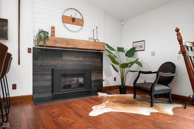 17216 W Hunnicut Rd, Cambridge City, IN 47327 - living area featuring hardwood / wood-style flooring, vaulted ceiling, and a tiled fireplace