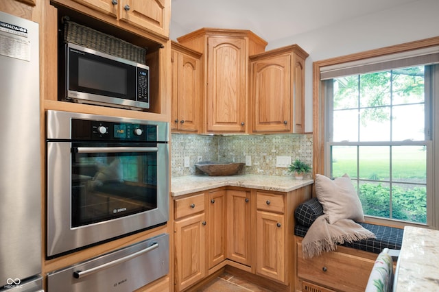 17216 W Hunnicut Rd, Cambridge City, IN 47327 - kitchen with stainless steel appliances, a warming drawer, backsplash, and light stone counters