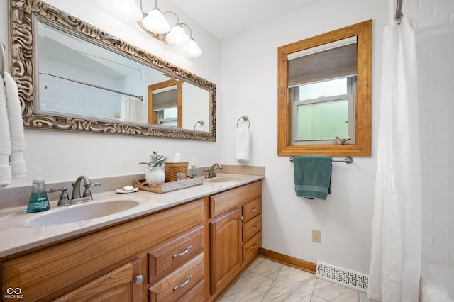 17216 W Hunnicut Rd, Cambridge City, IN 47327 - bathroom featuring double vanity and baseboards