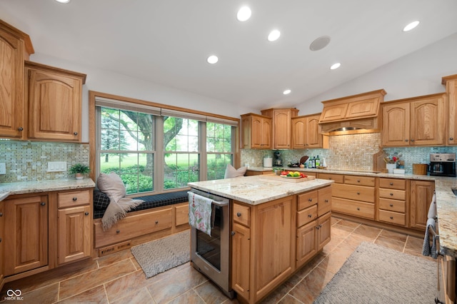17216 W Hunnicut Rd, Cambridge City, IN 47327 - kitchen with lofted ceiling, backsplash, light stone counters, a kitchen island, and premium range hood