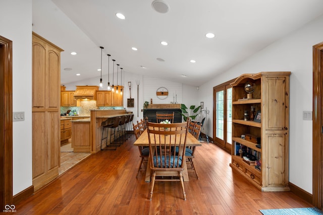 17216 W Hunnicut Rd, Cambridge City, IN 47327 - dining area featuring vaulted ceiling, light wood-style flooring, a fireplace, and recessed lighting