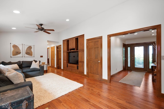 17216 W Hunnicut Rd, Cambridge City, IN 47327 - living room with a ceiling fan, light wood-type flooring, recessed lighting, vaulted ceiling, and crown molding
