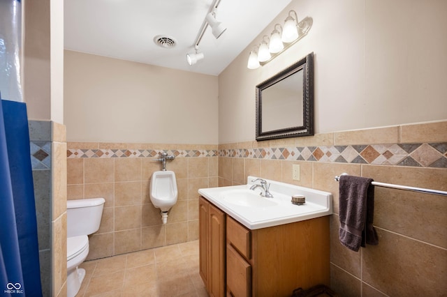 17216 W Hunnicut Rd, Cambridge City, IN 47327 - bathroom with tile walls, vanity, a wainscoted wall, and tile patterned flooring