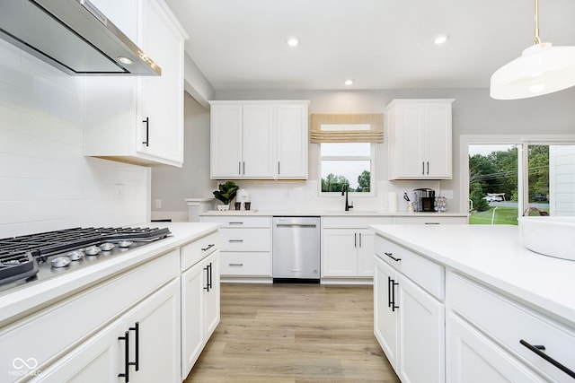 7242 Barrett Dr, Brownsburg, IN 46112 - kitchen with appliances with stainless steel finishes, wall chimney range hood, healthy amount of natural light, tasteful backsplash, and recessed lighting