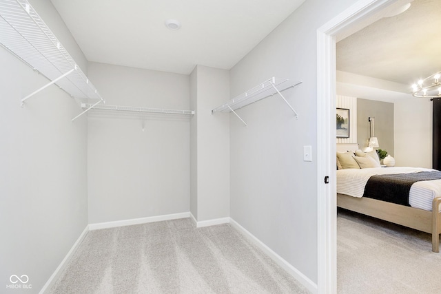 7242 Barrett Dr, Brownsburg, IN 46112 - walk in closet with carpet flooring and a chandelier