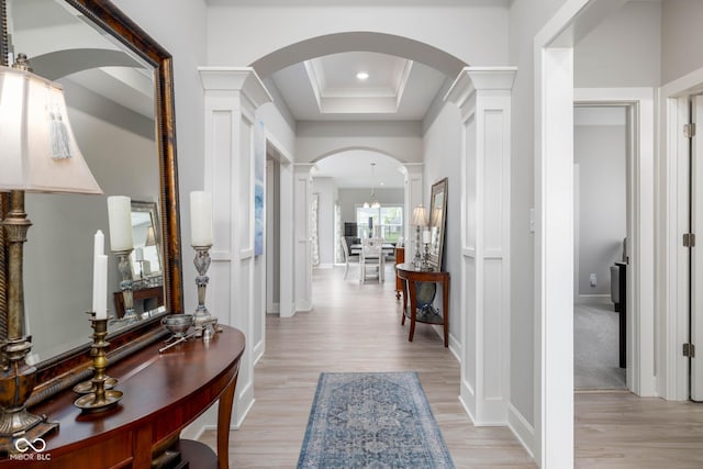 3622 S Setting Sun Ln, New Palestine, IN 46163 - entryway with decorative columns, arched walkways, light wood-style floors, a raised ceiling, and ornamental molding
