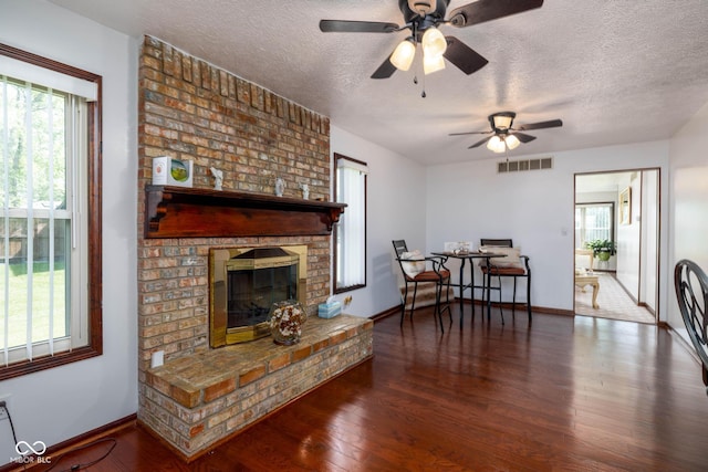 16226 Montrose Ln, Westfield, IN 46074 - living area featuring healthy amount of natural light, a textured ceiling, wood finished floors, and a ceiling fan