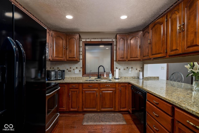 16226 Montrose Ln, Westfield, IN 46074 - kitchen with black appliances, a sink, a textured ceiling, dark wood finished floors, and backsplash