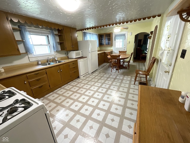 357 S Main St, Spencer, IN 47460 - kitchen featuring white appliances, a sink, light floors, and plenty of natural light