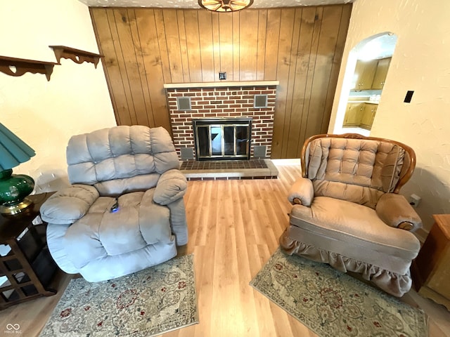 357 S Main St, Spencer, IN 47460 - living room with wooden walls, wood finished floors, and a brick fireplace
