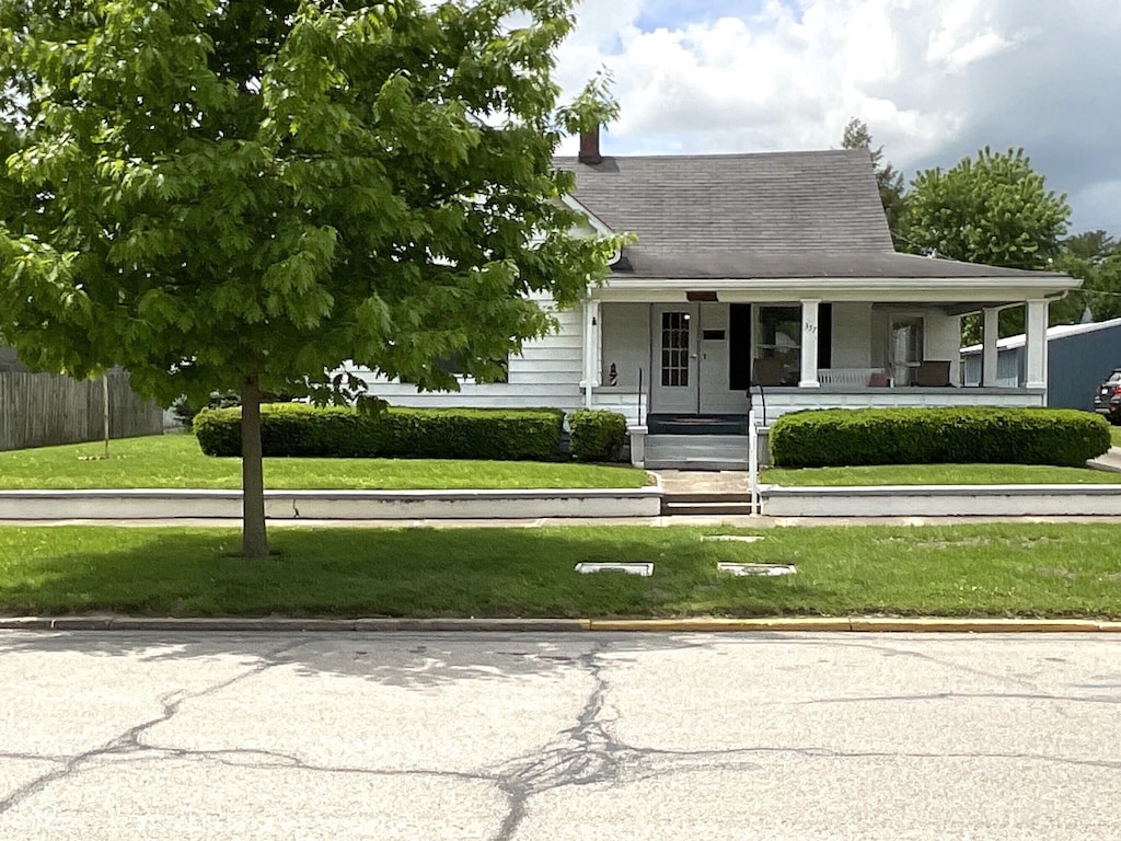 357 S Main St, Spencer, IN 47460 - view of front of home with covered porch and roof with shingles